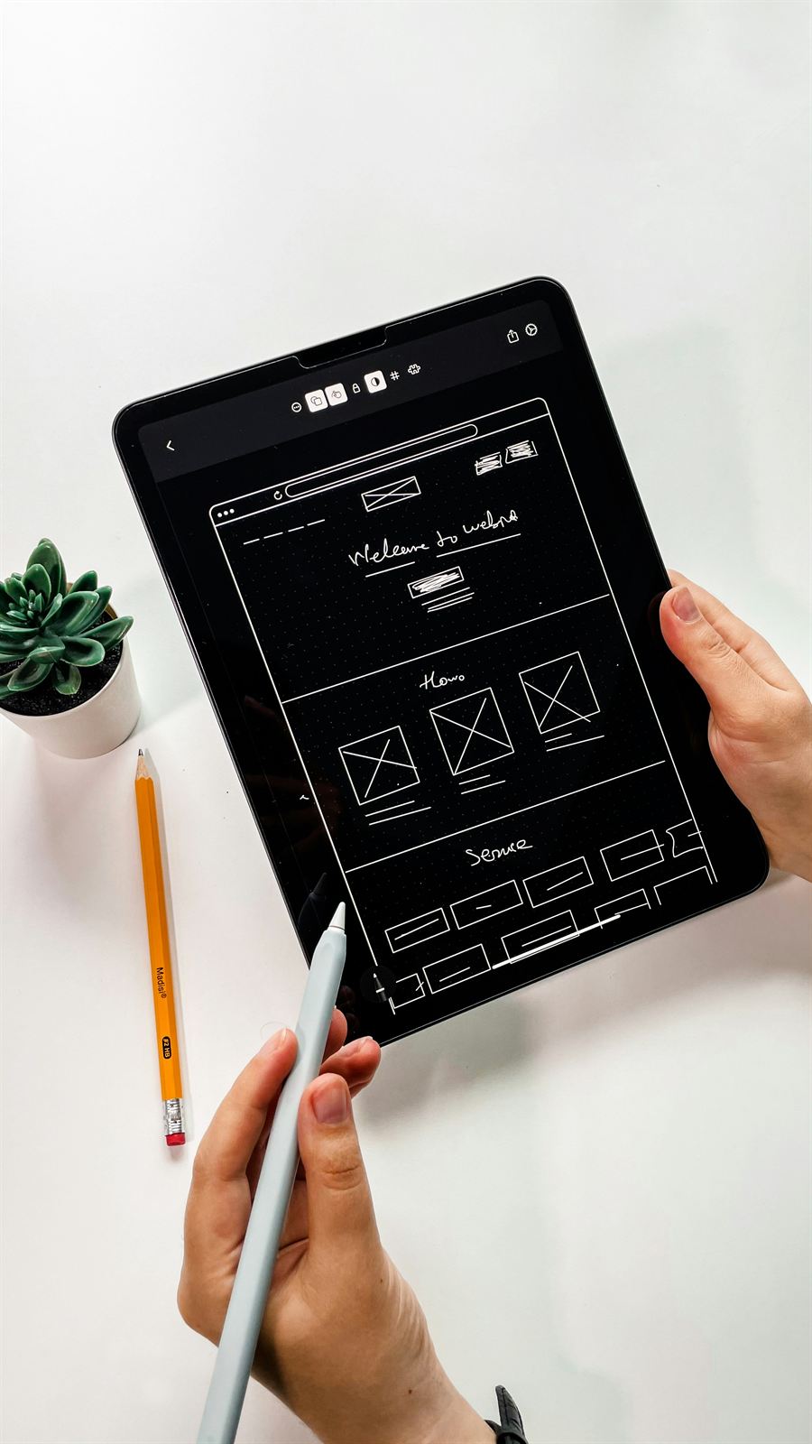 Freelance web designer sketching a website wireframe on a tablet, South Africa